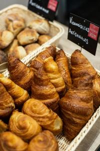 a bunch of pastries in baskets in a bakery at Hôtel Le Florin in Rennes