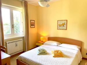 a bedroom with a bed with two yellow shoes on it at Inn Rome B&B in Ciampino