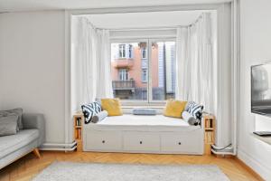 a living room with a couch and a window at Modern & Central Apartments in Luzern