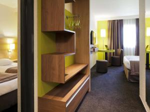 Un pat sau paturi într-o cameră la ibis Styles Chalon sur Saône