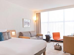 Кровать или кровати в номере Novotel Genève Centre