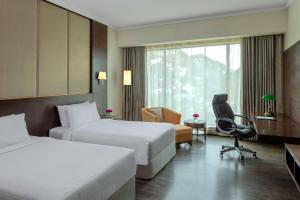 A bed or beds in a room at Radisson Blu Plaza Hotel Mysore