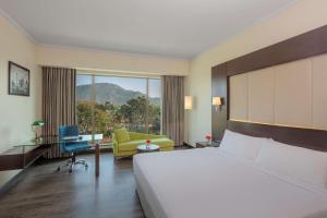 A bed or beds in a room at Radisson Blu Plaza Hotel Mysore