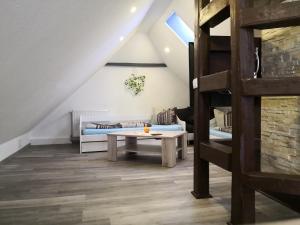 a living room with a bunk bed and a table at Hotel Villa Alice in Thale