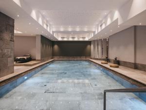 a swimming pool in a hotel room with a large pool at VAYA St Zeno Serfaus in Serfaus