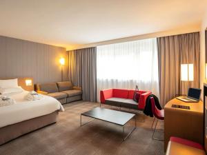 A bed or beds in a room at Novotel Roissy Saint Witz