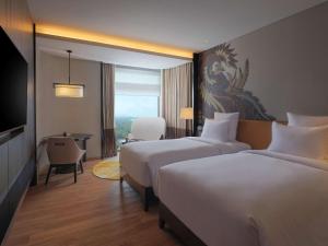 Cama ou camas em um quarto em Pullman Bandung Grand Central