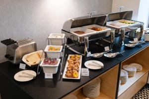 uma linha de buffet com muitos tipos diferentes de alimentos em Hotel Tulip Residences Warsaw Targowa em Varósvia