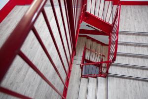 a red staircase inside of a gymnasium at Class'eco Charleroi in Charleroi