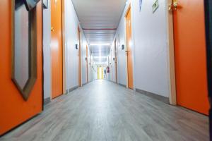 an empty corridor in an office building with orange walls at Class'eco Charleroi in Charleroi