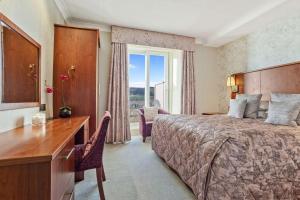 A bed or beds in a room at Ambleside Salutation Hotel & Spa, World Hotel Distinctive