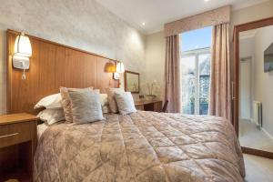 A bed or beds in a room at Ambleside Salutation Hotel & Spa, World Hotel Distinctive