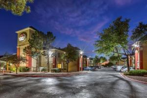 a street with a building and cars parked on the street at Suburban Studios in Albuquerque