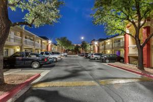 a street in a town with cars parked on the street at Suburban Studios in Albuquerque