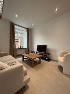 a living room with a couch and a coffee table at L'Apothèque - Résidence Le Cercle in Marche-en-Famenne