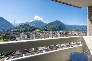 a balcony with a view of a city and mountains at Metropole Swiss Quality Hotel in Interlaken