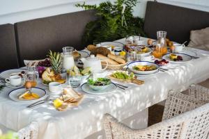 a table filled with breakfast food on a white table cloth at Casas Heddy, Well-being Resort in Puerto del Carmen