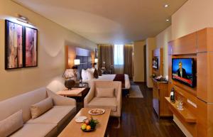 a large hotel room with a living room at Country Inn Panjim Goa in Panaji