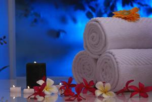 a cake with a stack of towels and a candle at Country Inn & Suites By Radisson Navi Mumbai in Navi Mumbai