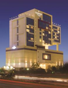 a building with a sign on it at night at Country Inn & Suites By Radisson Navi Mumbai in Navi Mumbai