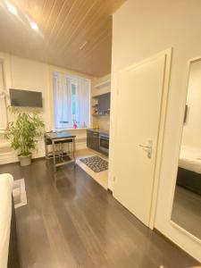 a living room with a table and a kitchen at B&B Guest House Du Lac in Montreux