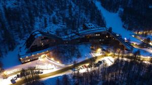 a building on the side of a mountain at night at Residence Petit Tibet in Breuil-Cervinia