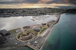 an aerial view of a harbor with boats in the water at Le Thalassa Hôtel & Spa in Camaret-sur-Mer