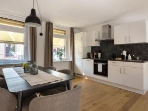 a kitchen and dining room with a table and chairs at limehome Baden-Baden Bäderstraße in Baden-Baden