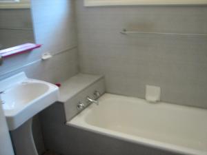 a bathroom with a sink and a bath tub next to a sink at Horace Street 8 in Shoal Bay