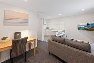 a living room with a couch and a table at Fawkner Executive Suites & Serviced Apartments in Melbourne