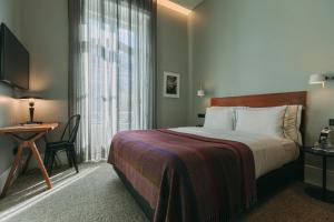 Tempat tidur dalam kamar di 1908 Lisboa Hotel