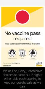 a sign that says no vaccine pass required at The_Cozy_Batch With a rural view in Whanganui