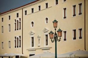 a street light in front of a large building at Ca'di Dio-Small Luxury Hotel in Venice