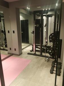 a gym with several treadmills and weights in a room at Anseong City Hotel in Anseong