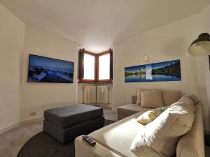 a living room with a couch and a chair at Aura Apartment - Ski In & Ski Out - Cerviniaholidays-com in Breuil-Cervinia