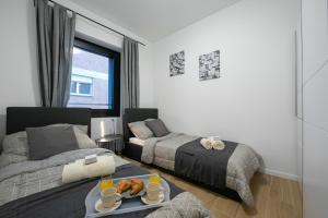 Una cama o camas en una habitación de Boutique Apartments - Happy Rentals