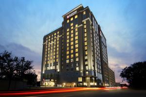 een hoog gebouw met 's nachts verlichting bij Blossom Hotel Houston in Houston