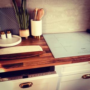 a kitchen counter with a cutting board and plants on it at Birdland Apartman in Bük