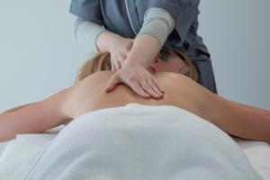 uma mulher a receber uma massagem de um terapeuta em Riva Toscana Golf Resort & SPA em Follonica