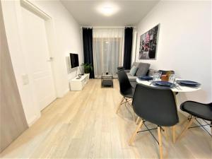 a living room with a table and chairs at EXCLUSIVE 2BR! Apartment in CENTER +NETFLIX +GYM in Warsaw