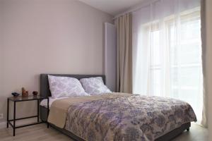 a bedroom with a bed and a large window at EXCLUSIVE 2BR! Apartment in CENTER +NETFLIX +GYM in Warsaw