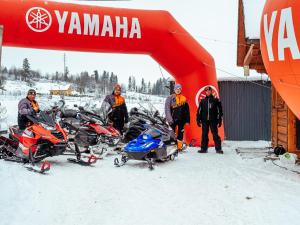 a group of people standing in the snow next to motorcycles at Hotel Liptakówka in Białka Tatrzanska