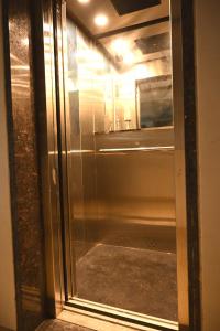 a glass door of an oven in a room at Majestic Hotel in Nashik