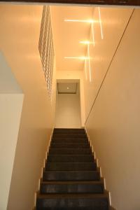 a staircase with a cross on the wall and a stair case at Majestic Hotel in Nashik