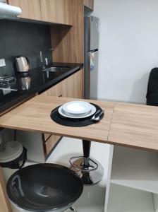 a kitchen with a wooden table with plates on it at Tuareg Suite Deluxe in Santa Cruz de la Sierra