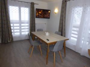 a dining room with a wooden table and chairs at Chalet Monte-Pente in Megève