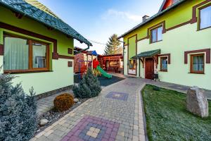 a house with a playground in the backyard at Emerald House in Mykulychyn