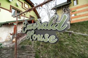 a sign that reads emerald house hanging in front of a house at Emerald House in Mykulychyn