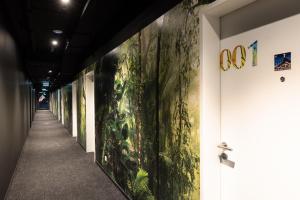 a hallway with paintings of plants on the wall at Rioca Stuttgart Posto 4 in Stuttgart