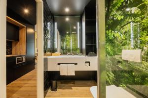 a bathroom with a white sink and a green wall at Rioca Stuttgart Posto 4 in Stuttgart